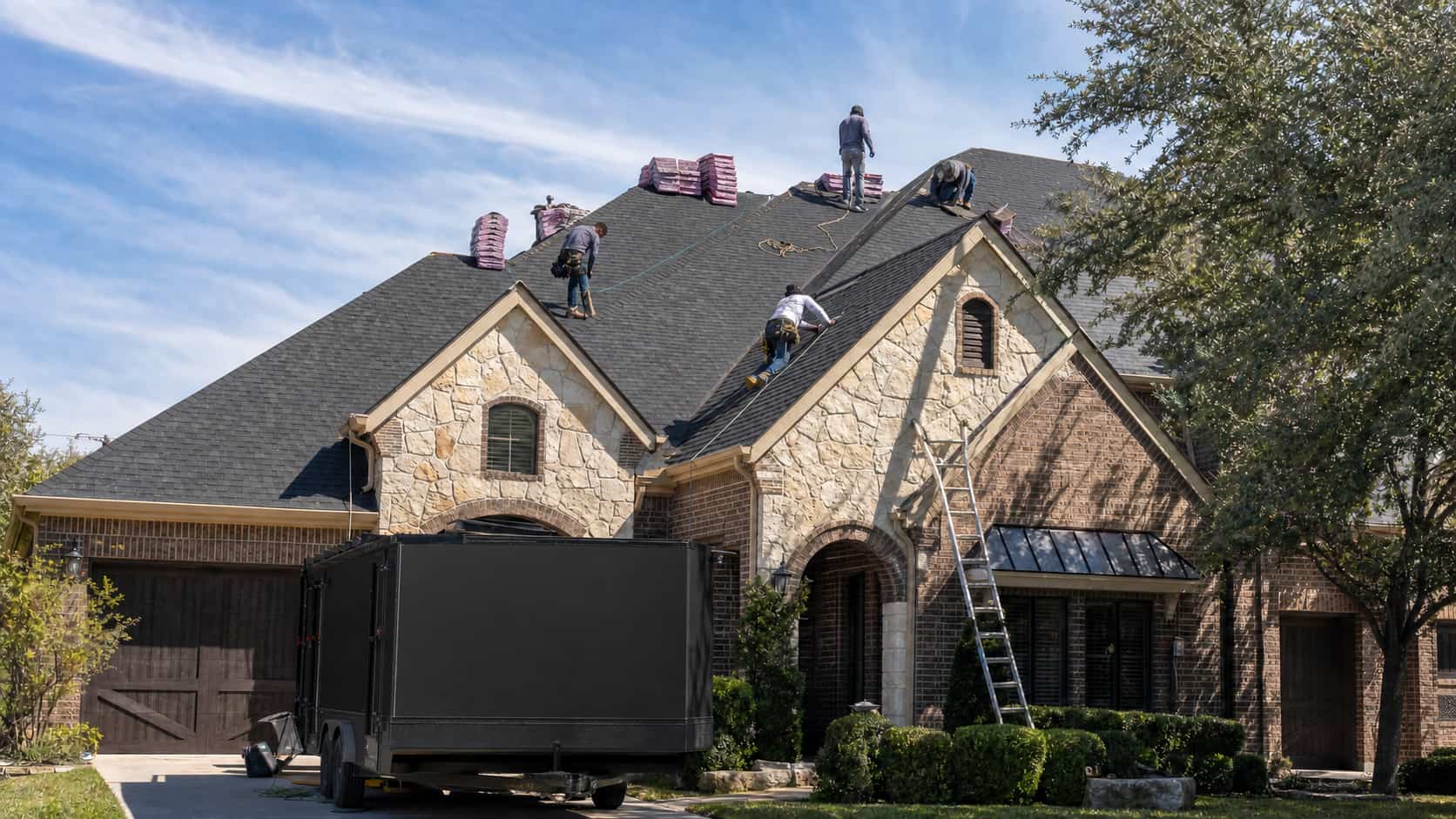 Roof installation crew installing new shingles on an Austin home